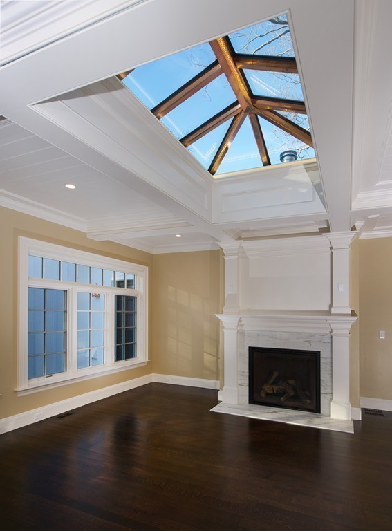 44 Valley Road Wellesley, MA 02481 - Photo 9 of 30 a living room with a fireplace and wooden floor