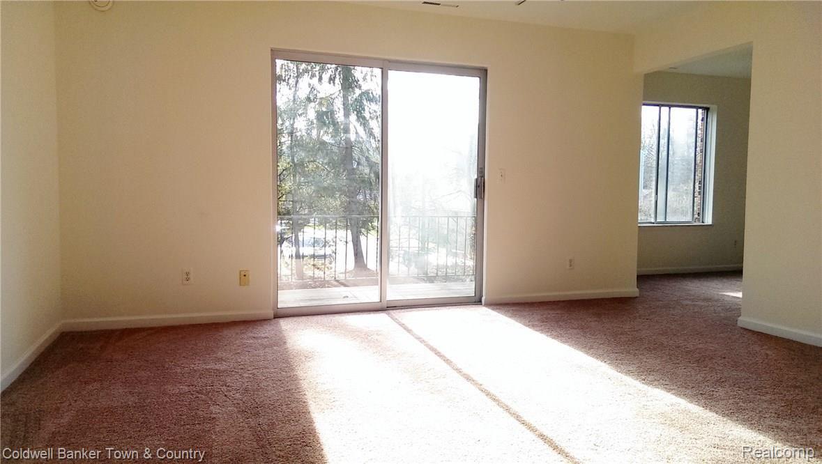 505 West Highland Road, Unit 9 Howell, MI 48843 - Photo 2 of 15 Living Room leading to Dining Room