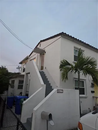 a view of a house with a palm tree