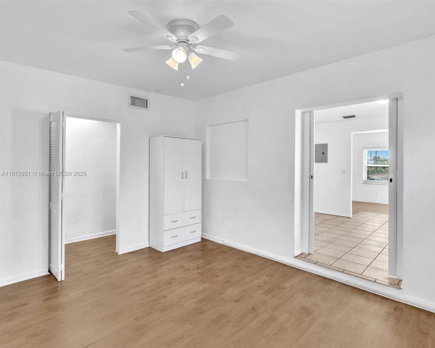 3415 Southwest 15th Street, Unit 2 Miami, FL 33145 - Photo 6 of 11 an empty room with closet and a ceiling fan
