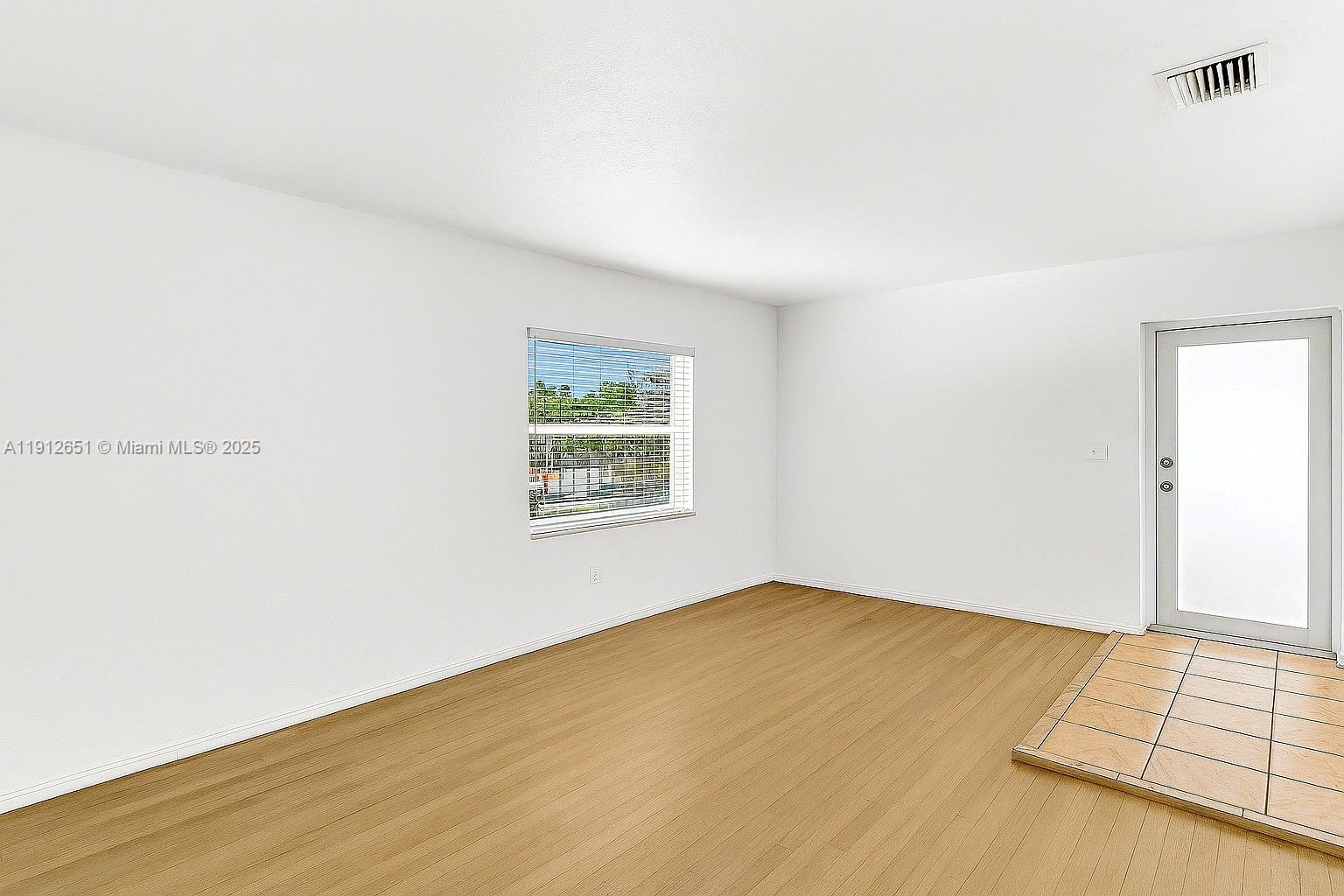 3415 Southwest 15th Street, Unit 2 Miami, FL 33145 - Photo 7 of 11 an empty room with a window