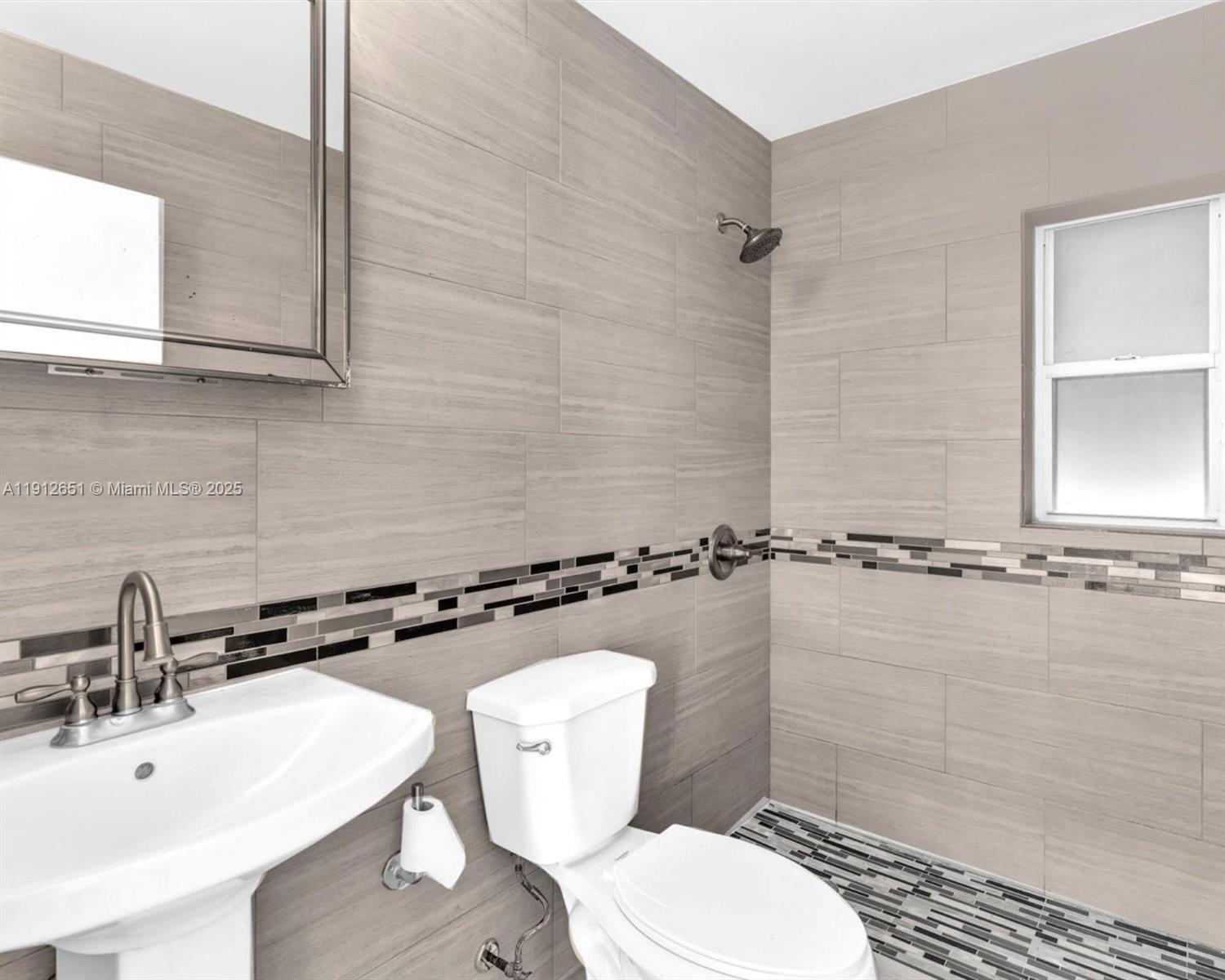 3415 Southwest 15th Street, Unit 2 Miami, FL 33145 - Photo 10 of 11 a bathroom with a sink toilet and shower