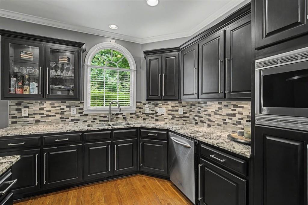 122 Ridge View Drive Ball Ground, GA 30107 - Photo 26 of 84 a kitchen with stainless steel appliances granite countertop stove sink microwave and window