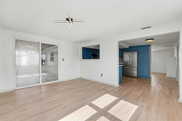 a big room with wooden floor and windows