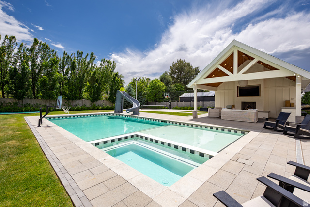 630 East Center Street Alpine, UT 84004 - Photo 107 of 115 Expansive outdoor area featuring a swimming pool, integrated spa, and a pool house with a vaulted ceiling and exposed beams
