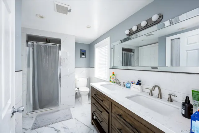 a spacious bathroom with a double vanity sink mirror and