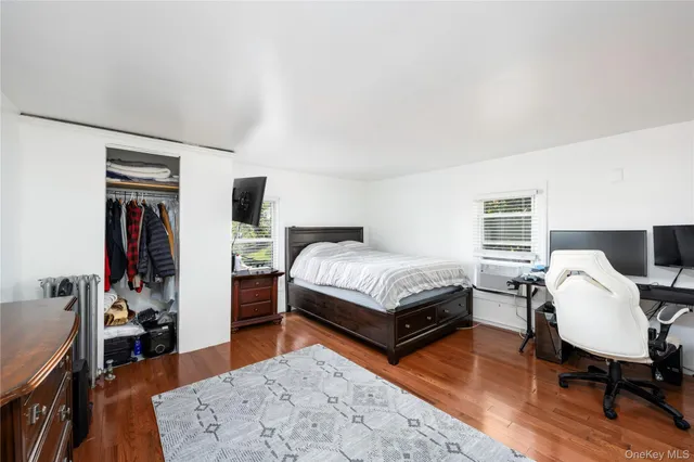 a bedroom with furniture and a wooden floor