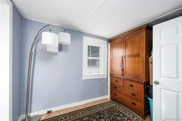 a view of a livingroom with wooden floor and cabinet