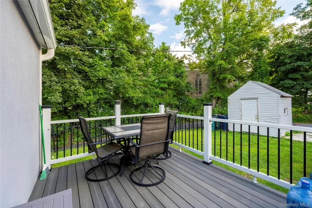 a view of a deck with chair and wooden floor