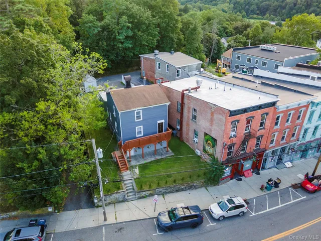 an aerial view of a house with garden space and street view