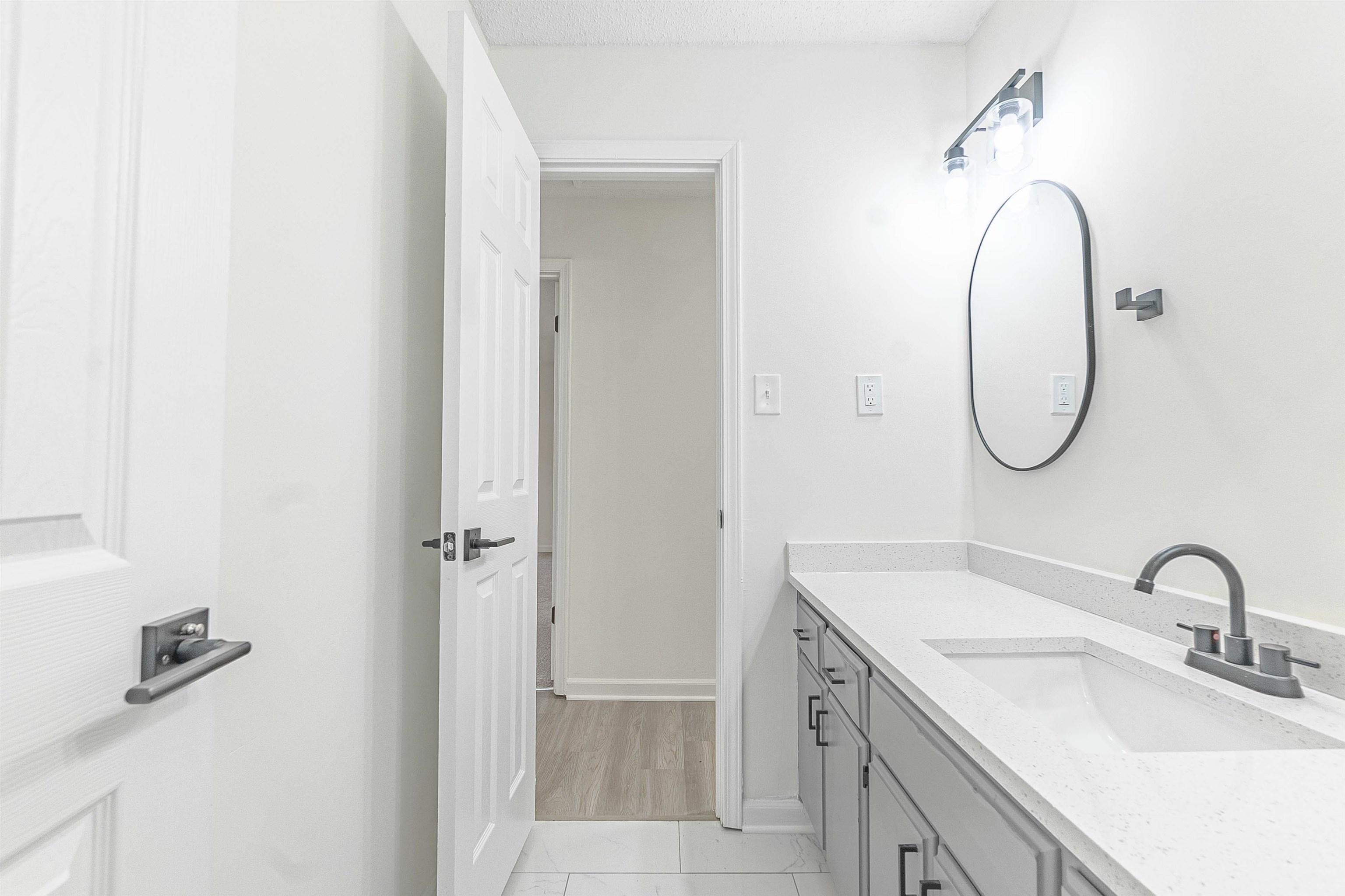 6538 Castle Ridge Cove Memphis, TN 38141 - Photo 19 of 27 Bathroom with a textured ceiling, vanity, and hardwood / wood-style flooring