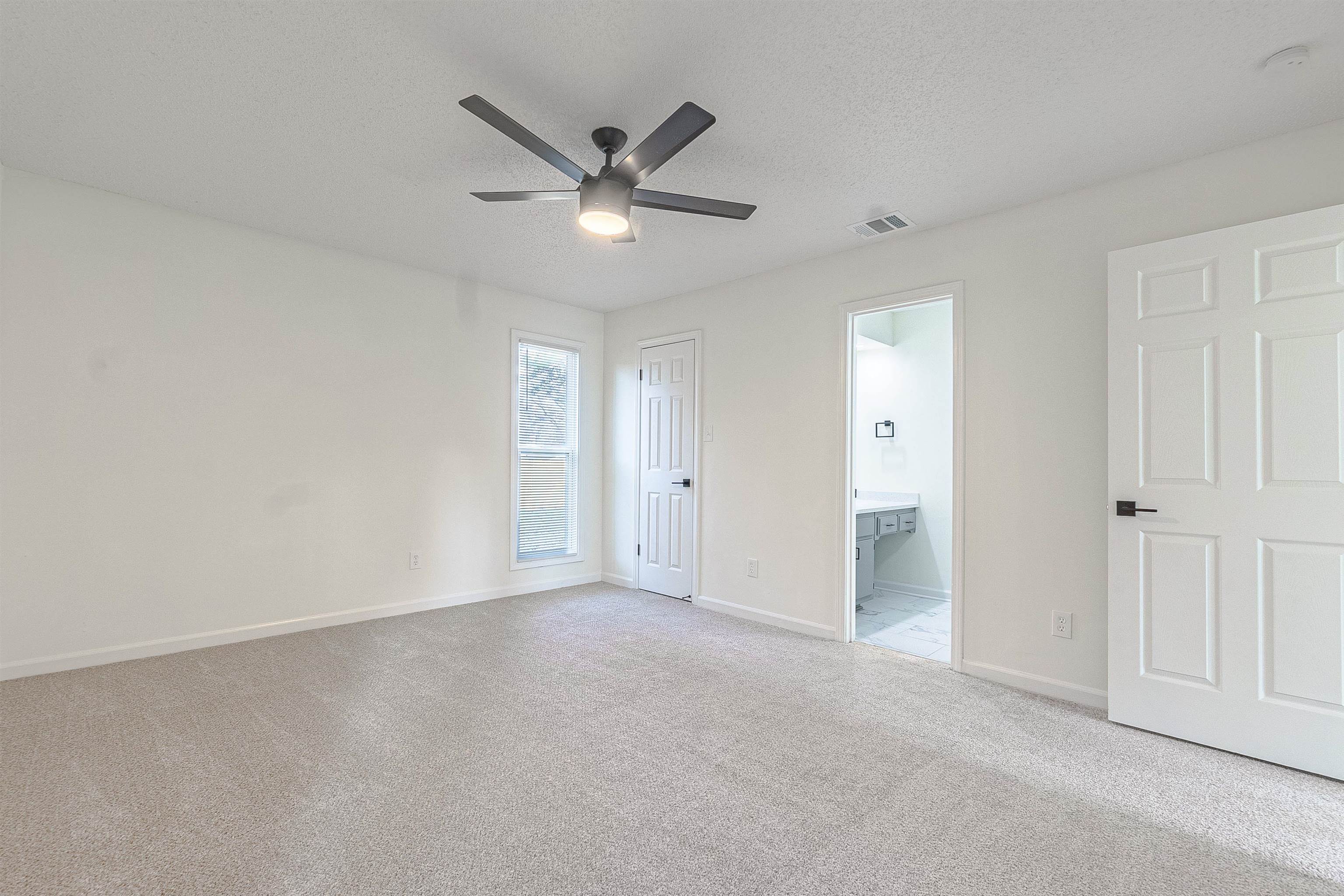 6538 Castle Ridge Cove Memphis, TN 38141 - Photo 20 of 27 Unfurnished bedroom with ceiling fan, ensuite bathroom, light colored carpet, a textured ceiling, and a closet