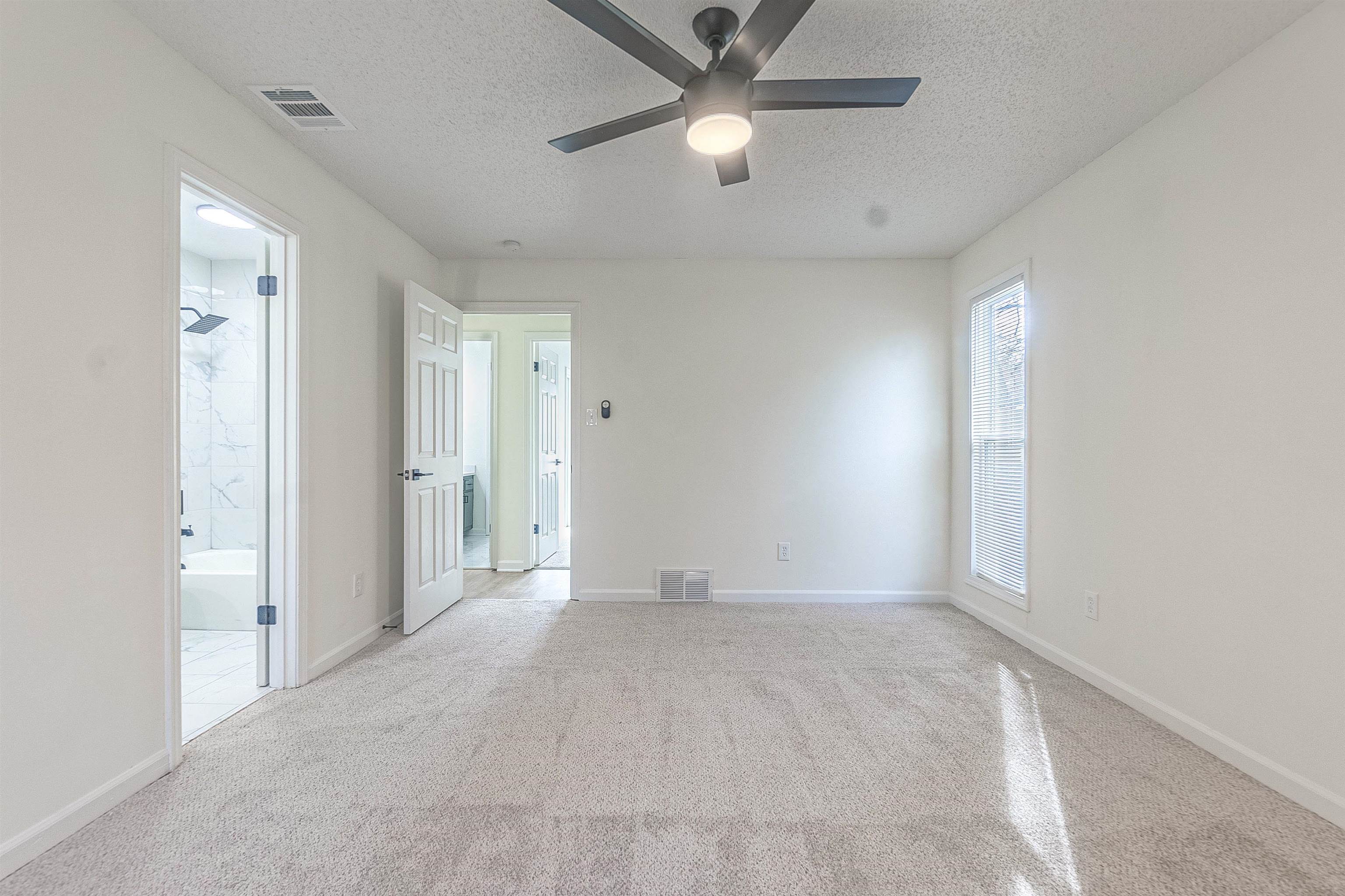 6538 Castle Ridge Cove Memphis, TN 38141 - Photo 21 of 27 Carpeted empty room featuring ceiling fan and a textured ceiling