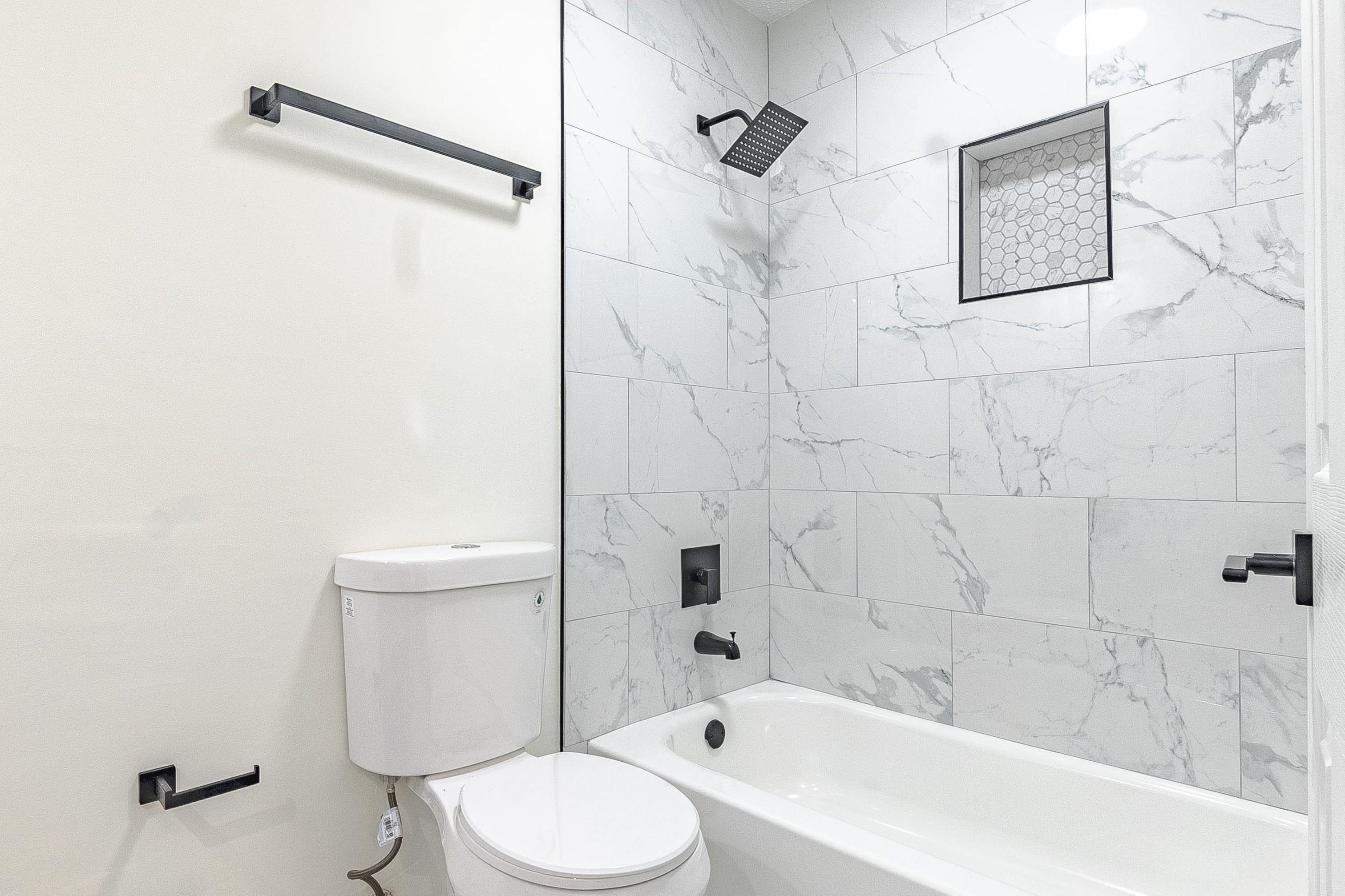 6538 Castle Ridge Cove Memphis, TN 38141 - Photo 22 of 27 Bathroom with tiled shower / bath combo and toilet
