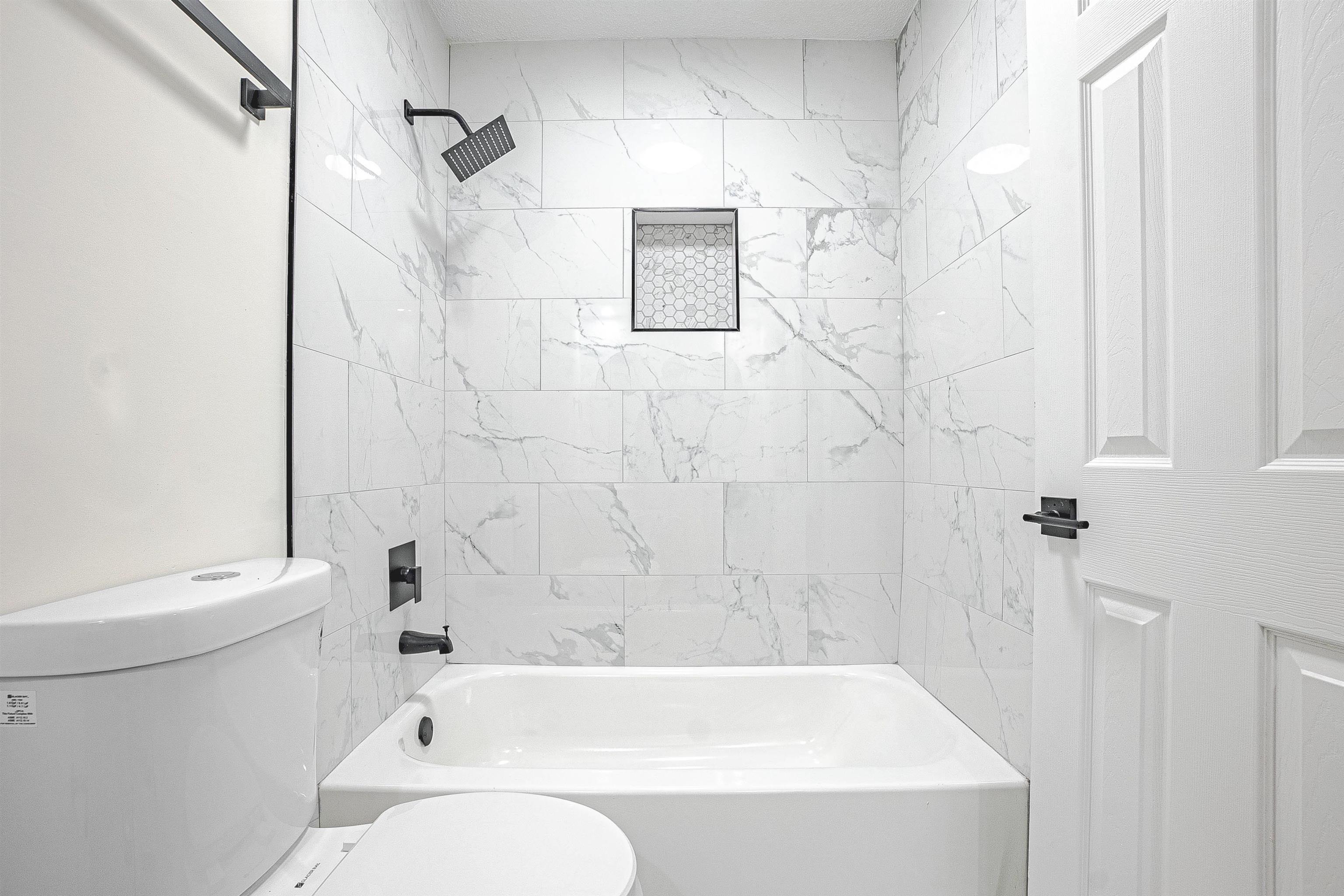 6538 Castle Ridge Cove Memphis, TN 38141 - Photo 23 of 27 Bathroom with tiled shower / bath combo and toilet