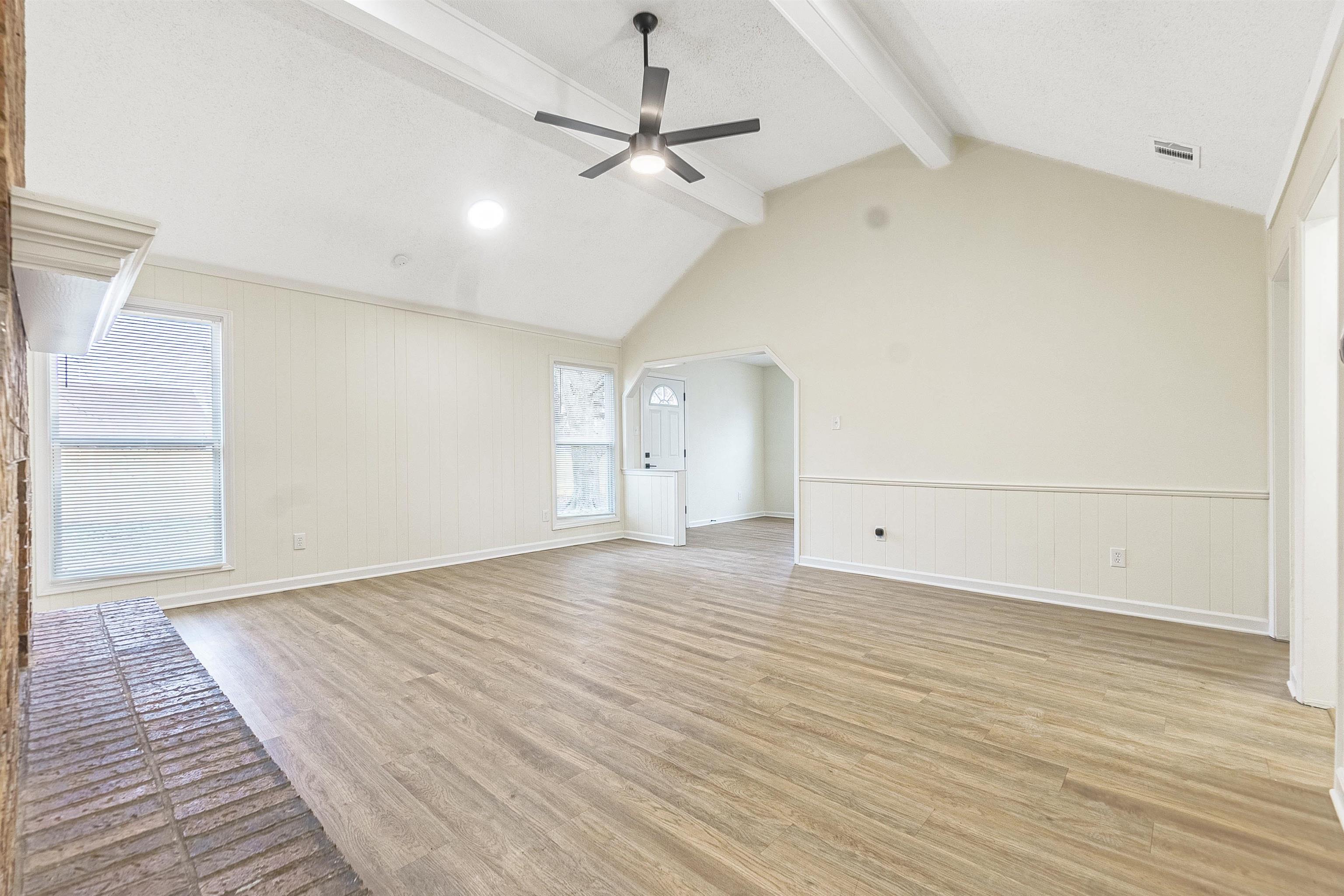 6538 Castle Ridge Cove Memphis, TN 38141 - Photo 6 of 27 Unfurnished living room featuring vaulted ceiling with beams, ceiling fan, and light wood-type flooring