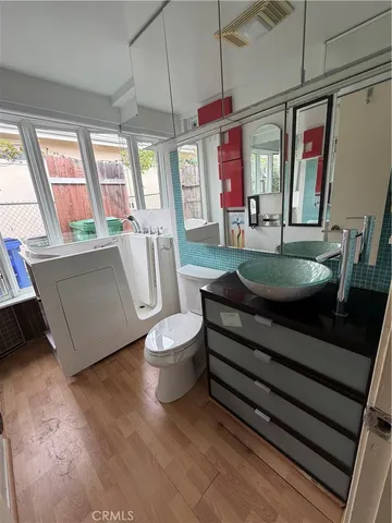 a living room with furniture a flat screen tv and a large window