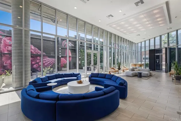 a living room with furniture and a view of kitchen