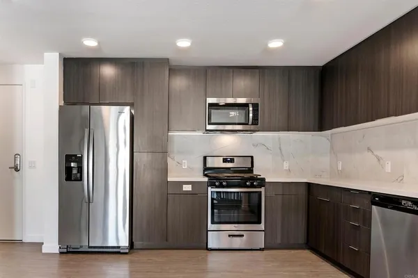 a kitchen with stainless steel appliances granite countertop a stove and a sink