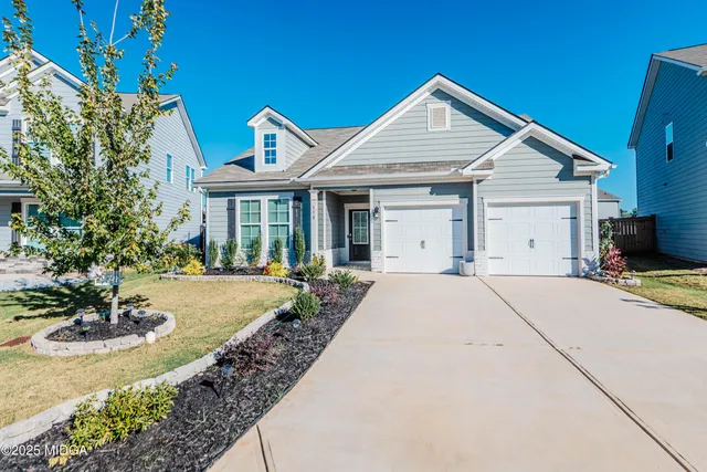 a view of a house with pool and garden