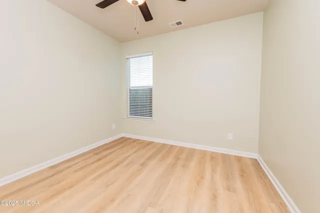 an empty room with a empty space and a window