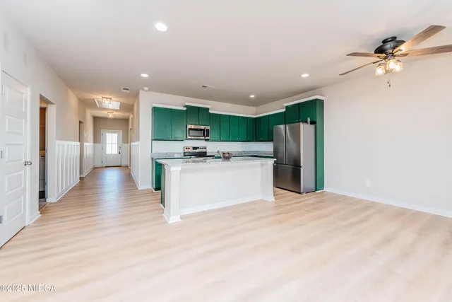 a view of kitchen with cabinets and stainless steel appliances