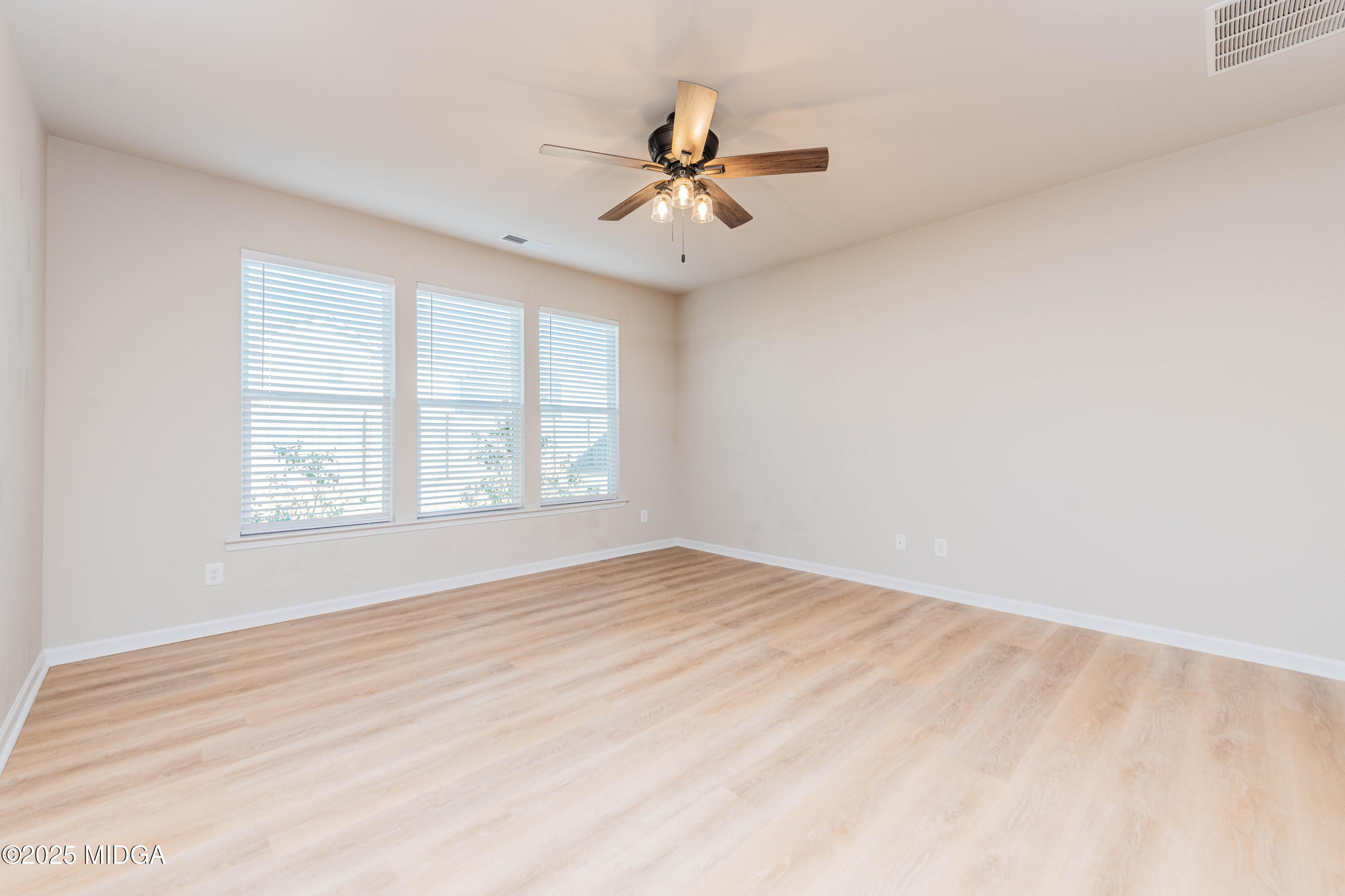 116 Red Birch Lane Warner Robins, GA 31093 - Photo 17 of 34 an empty room with windows and ceiling fan