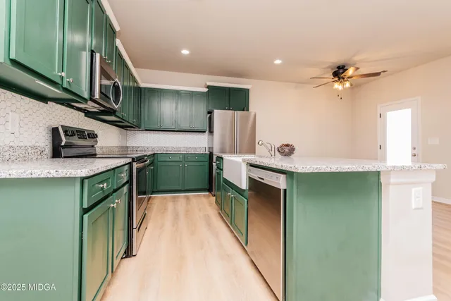 a kitchen with stainless steel appliances granite countertop a sink and dishwasher