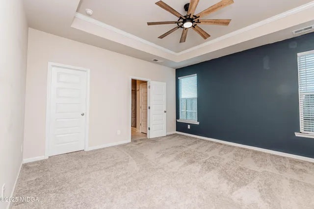 a view of a livingroom with a ceiling fan and window