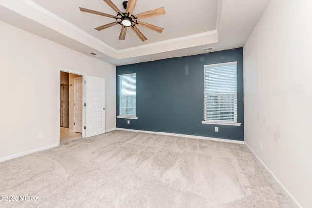 a view of a livingroom with a ceiling fan and window