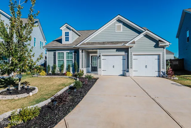 a front view of a house with garden