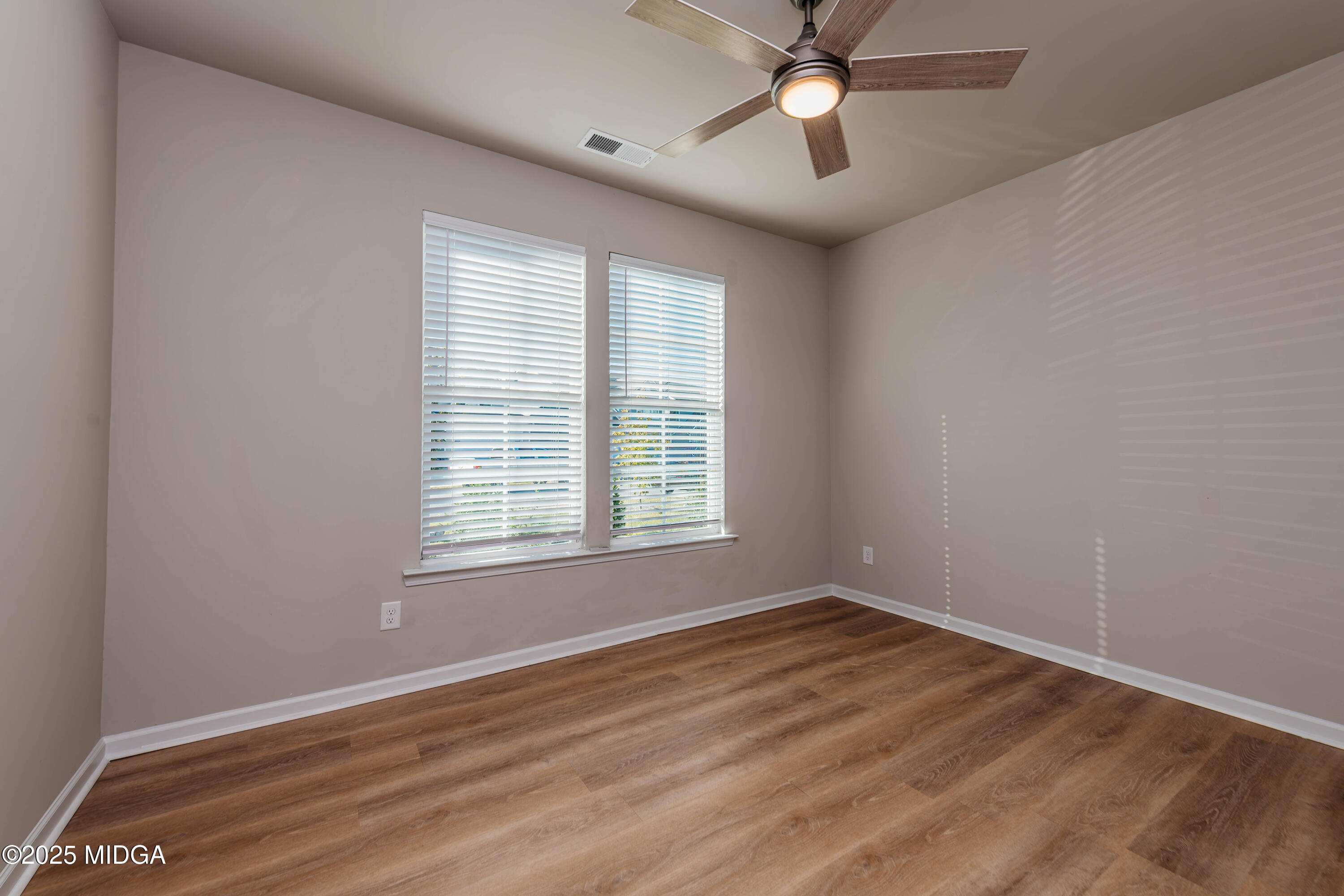 116 Red Birch Lane Warner Robins, GA 31093 - Photo 5 of 34 a view of an empty room with wooden floor and a window