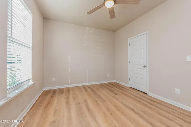 wooden floor in an empty room with a window