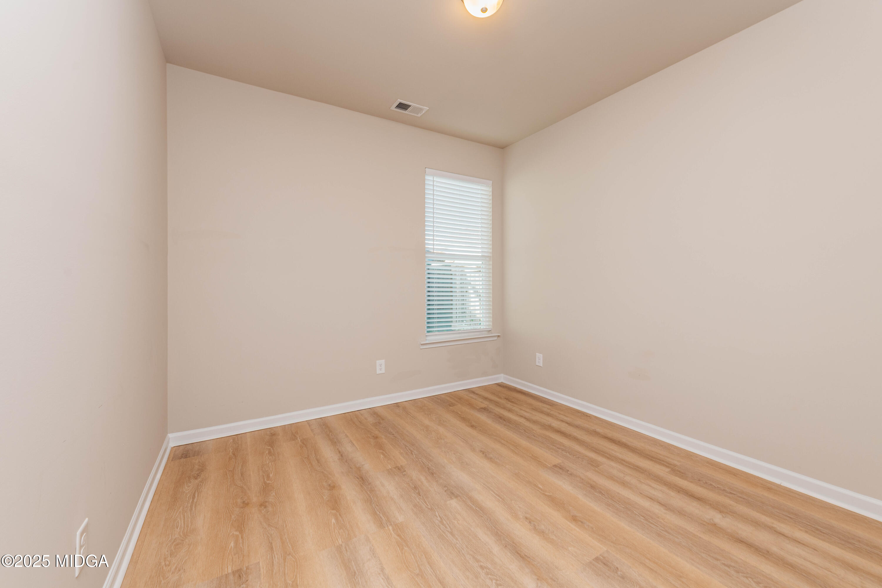 116 Red Birch Lane Warner Robins, GA 31093 - Photo 8 of 34 a view of an empty room with wooden floor