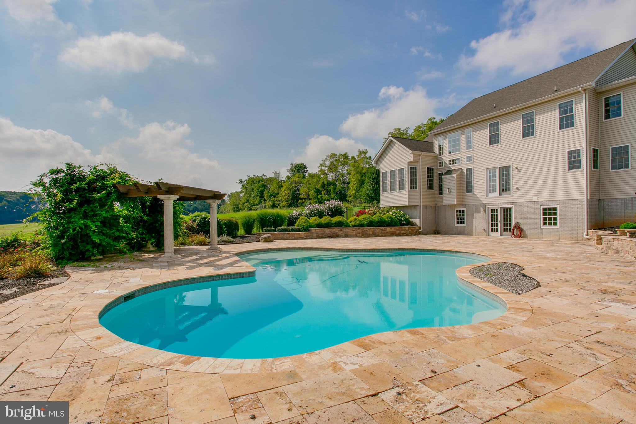4628 Dave Rill Road Hampstead, MD 21074 - Photo 23 of 30 a view of a white house with a swimming pool and sitting area