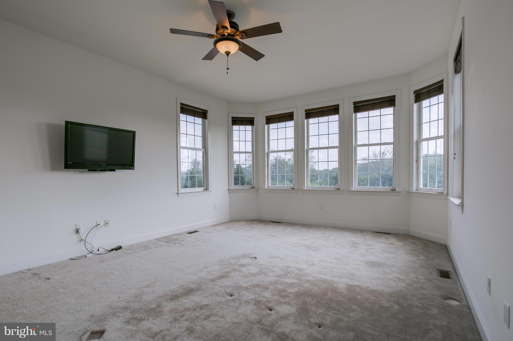 4628 Dave Rill Road Hampstead, MD 21074 - Photo 6 of 30 a view of an empty room with a window and a flat screen tv