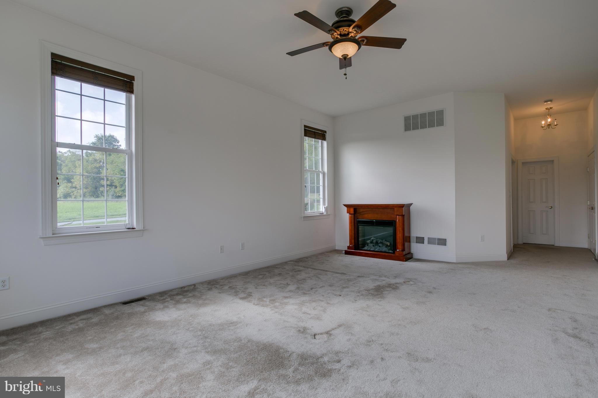 4628 Dave Rill Road Hampstead, MD 21074 - Photo 7 of 30 an empty room with windows and fan