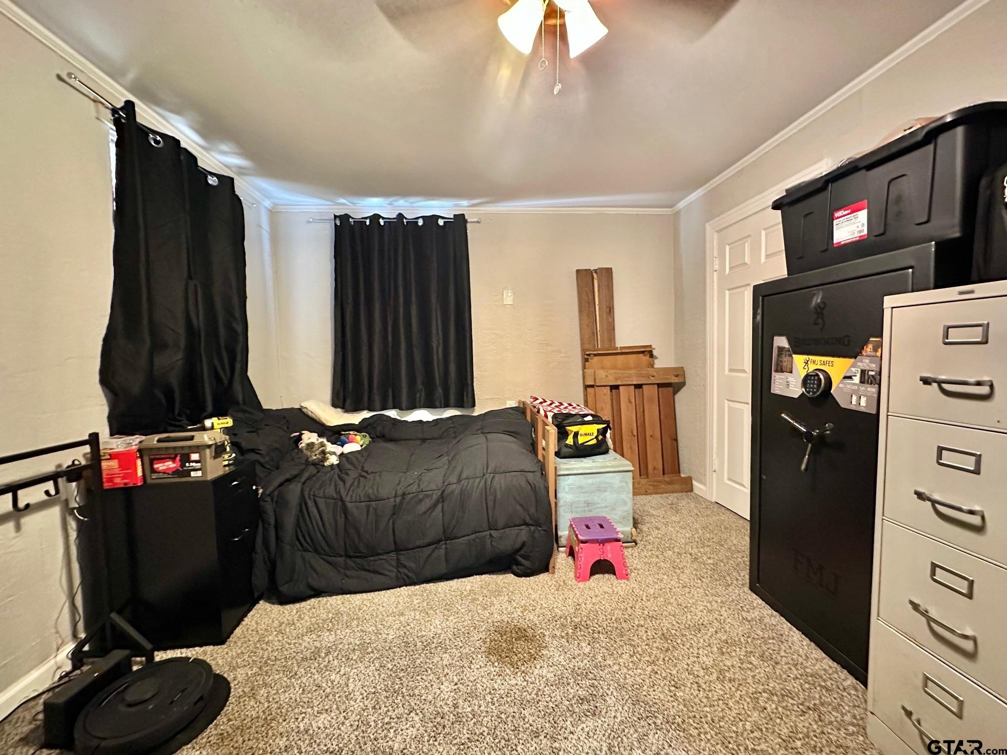 2601 East George Richey Road Longview, TX 75604 - Photo 23 of 26 a bedroom with a bed and a flat tv screen