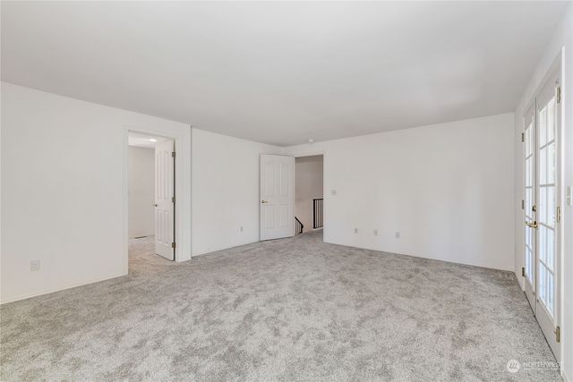 a view of an empty room and a window