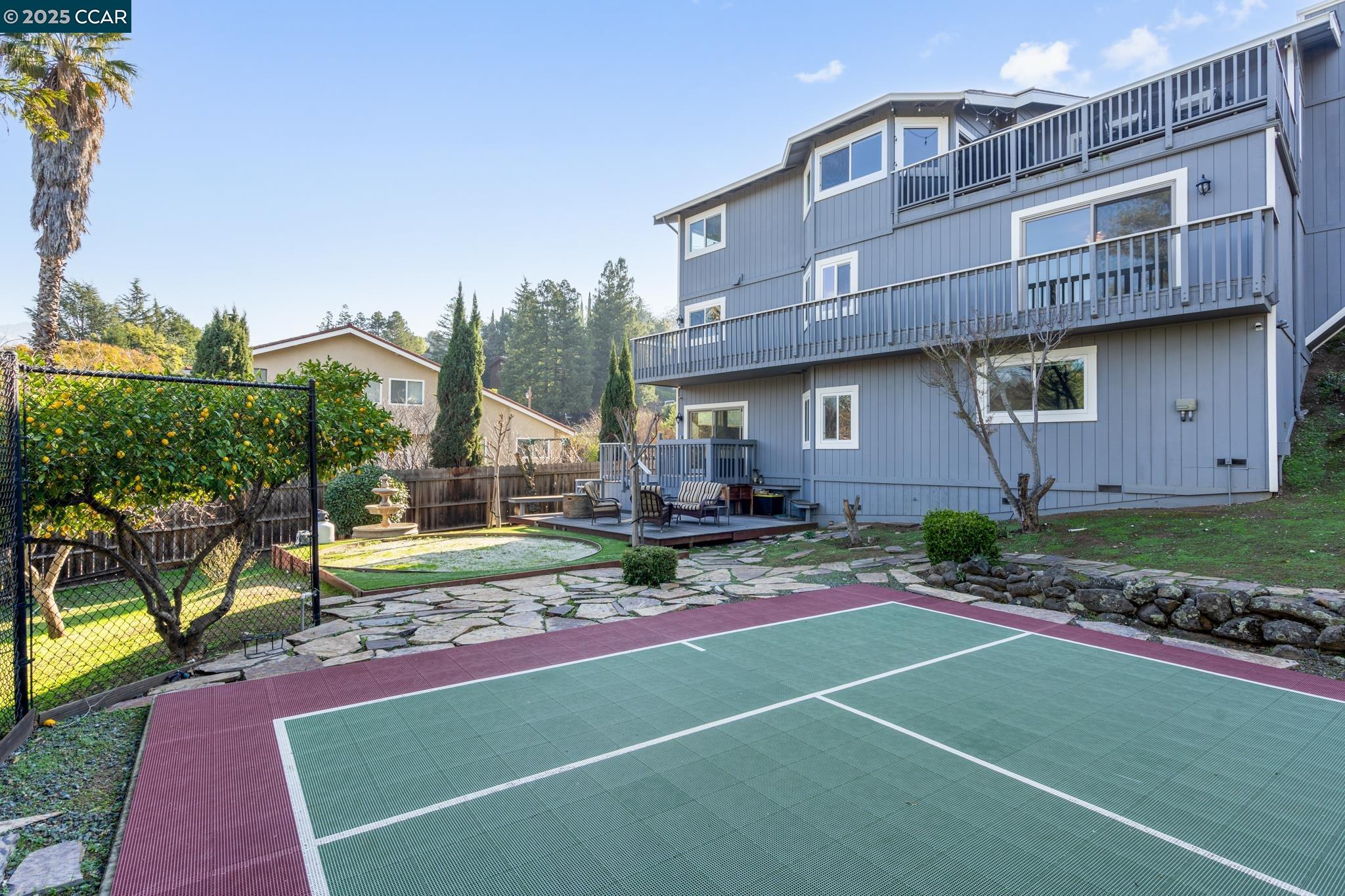 a backyard of a house with table and chairs