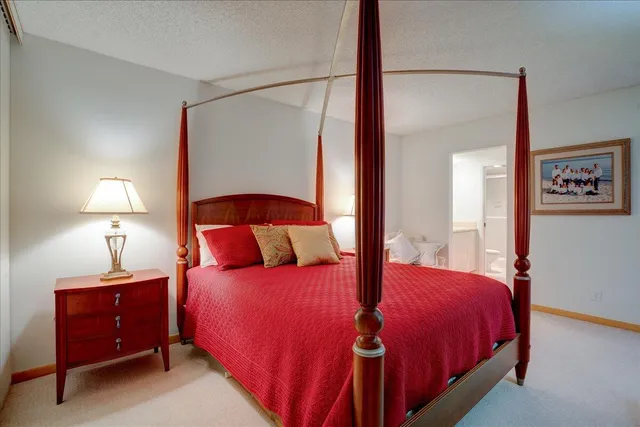 a bedroom with a bed and a lamp