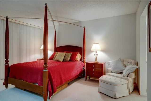 a bedroom with a bed and a lamp