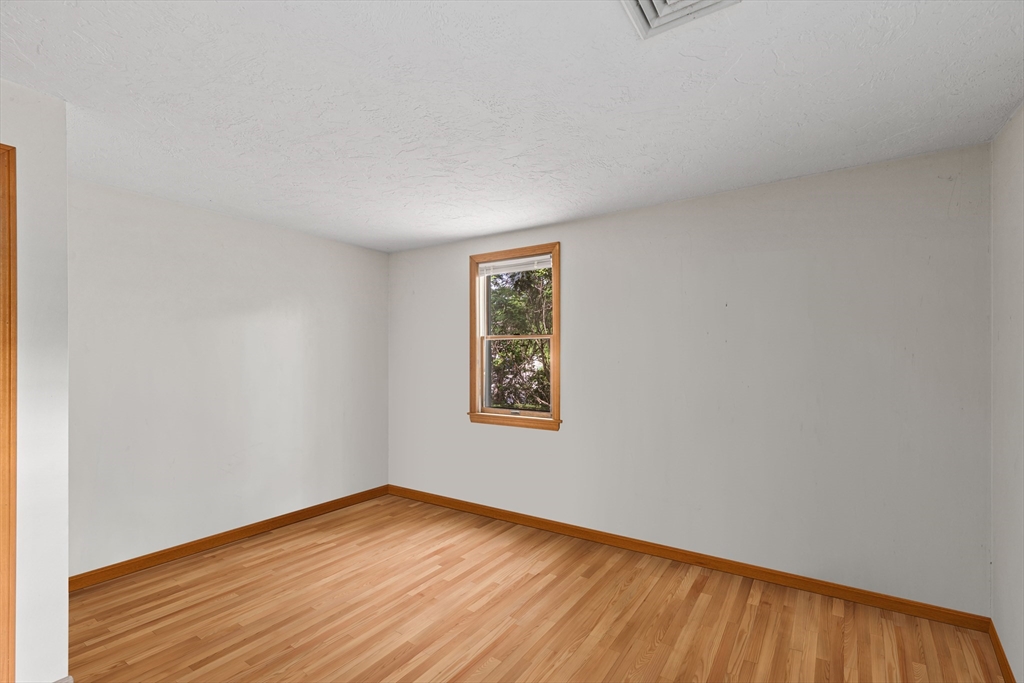 34 Diandy Road Bourne, MA 02562 - Photo 17 of 20 a view of an empty room with wooden floor and a window