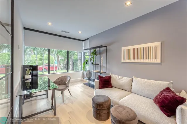 a living room with furniture and a floor to ceiling window