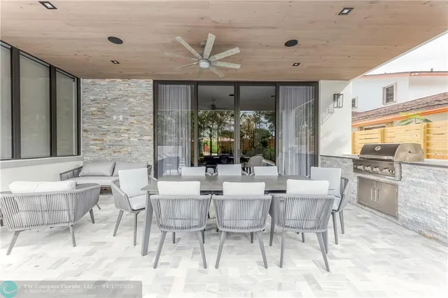 a dining room with furniture and large windows