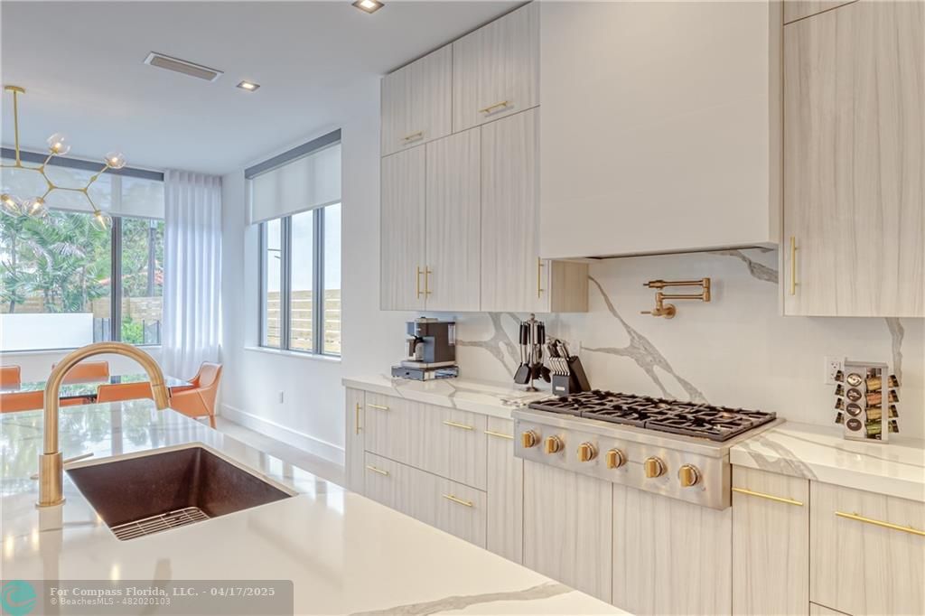 2929 Center Avenue Fort Lauderdale, FL 33308 - Photo 19 of 35 a kitchen with stainless steel appliances granite countertop a sink stove and white cabinets