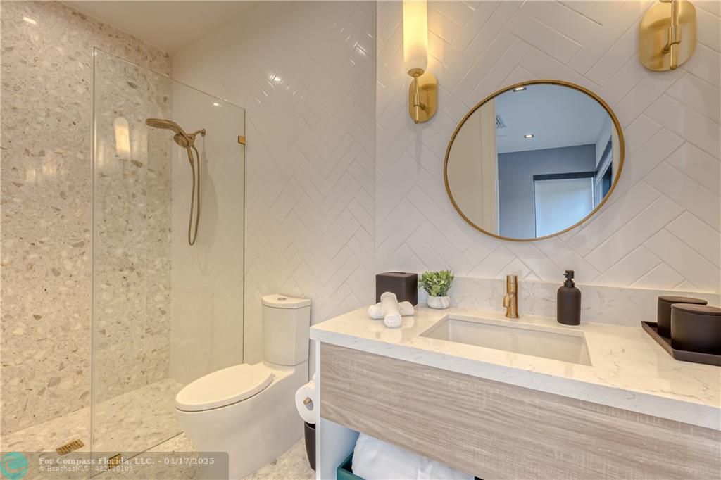 2929 Center Avenue Fort Lauderdale, FL 33308 - Photo 23 of 35 a bathroom with a sink a toilet and a mirror