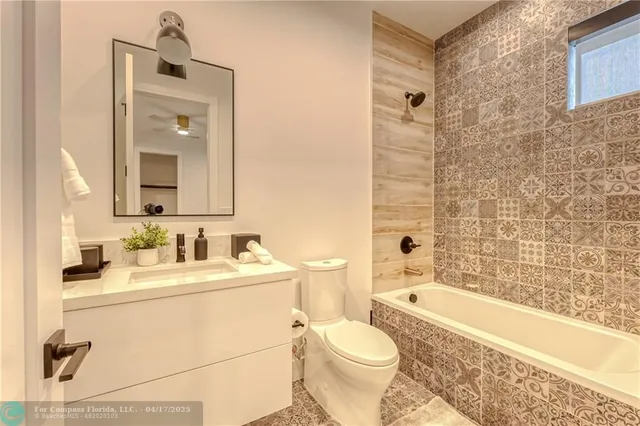 a bathroom with a sink mirror toilet and bathtub