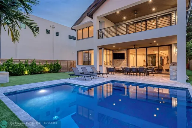 a view of swimming pool with outdoor seating
