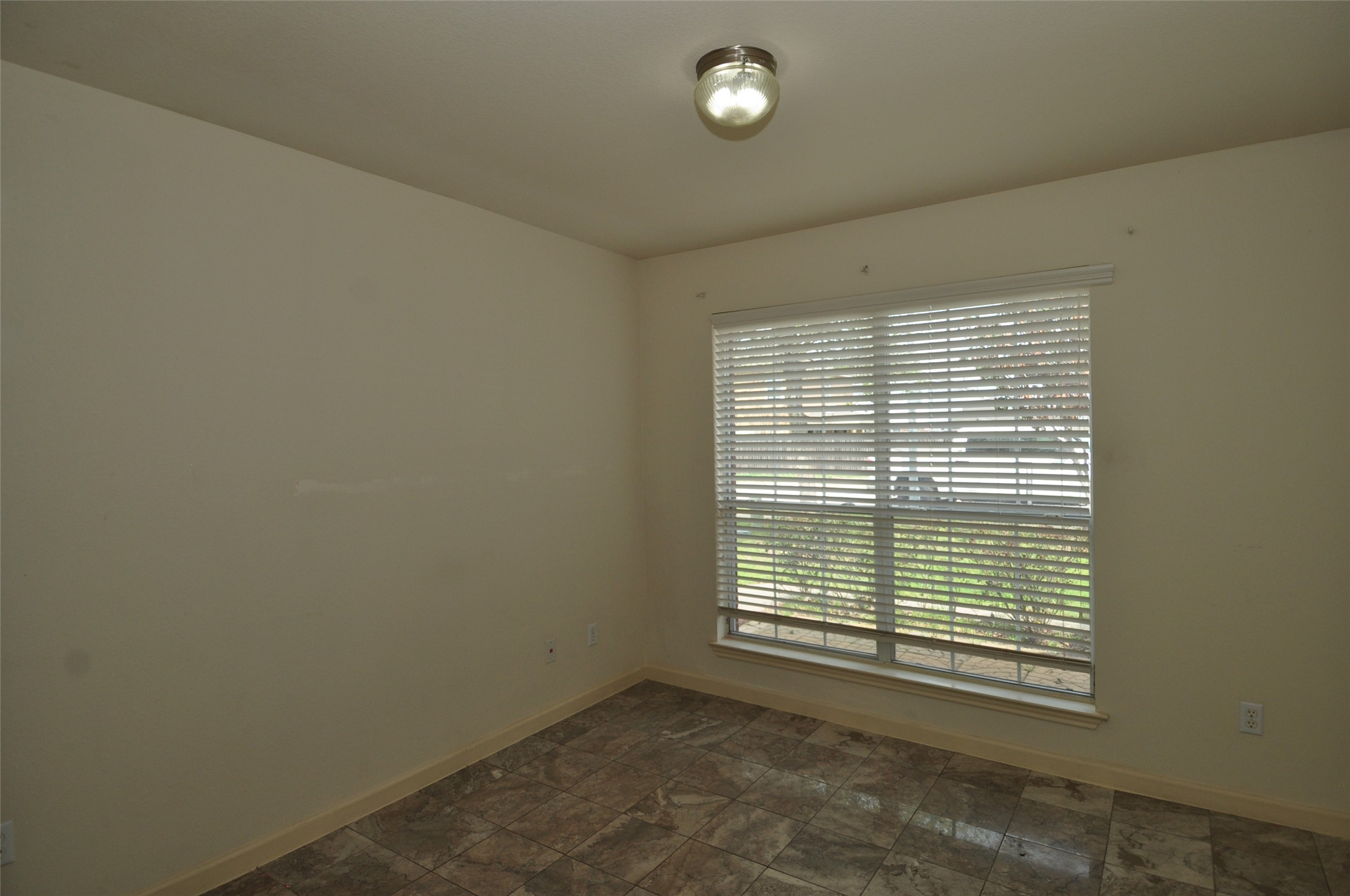 1409 Tea Leaf Drive Pflugerville, TX 78660 - Photo 13 of 18 A well-lit interior space features sleek tile flooring and a window providing natural light.